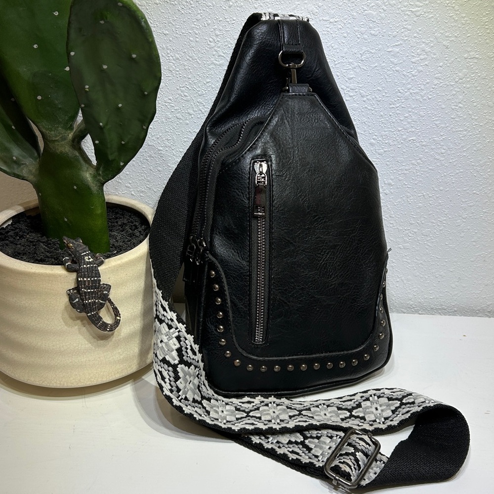 Sam & Hadley studded sling bag with a patterned guitar-style strap